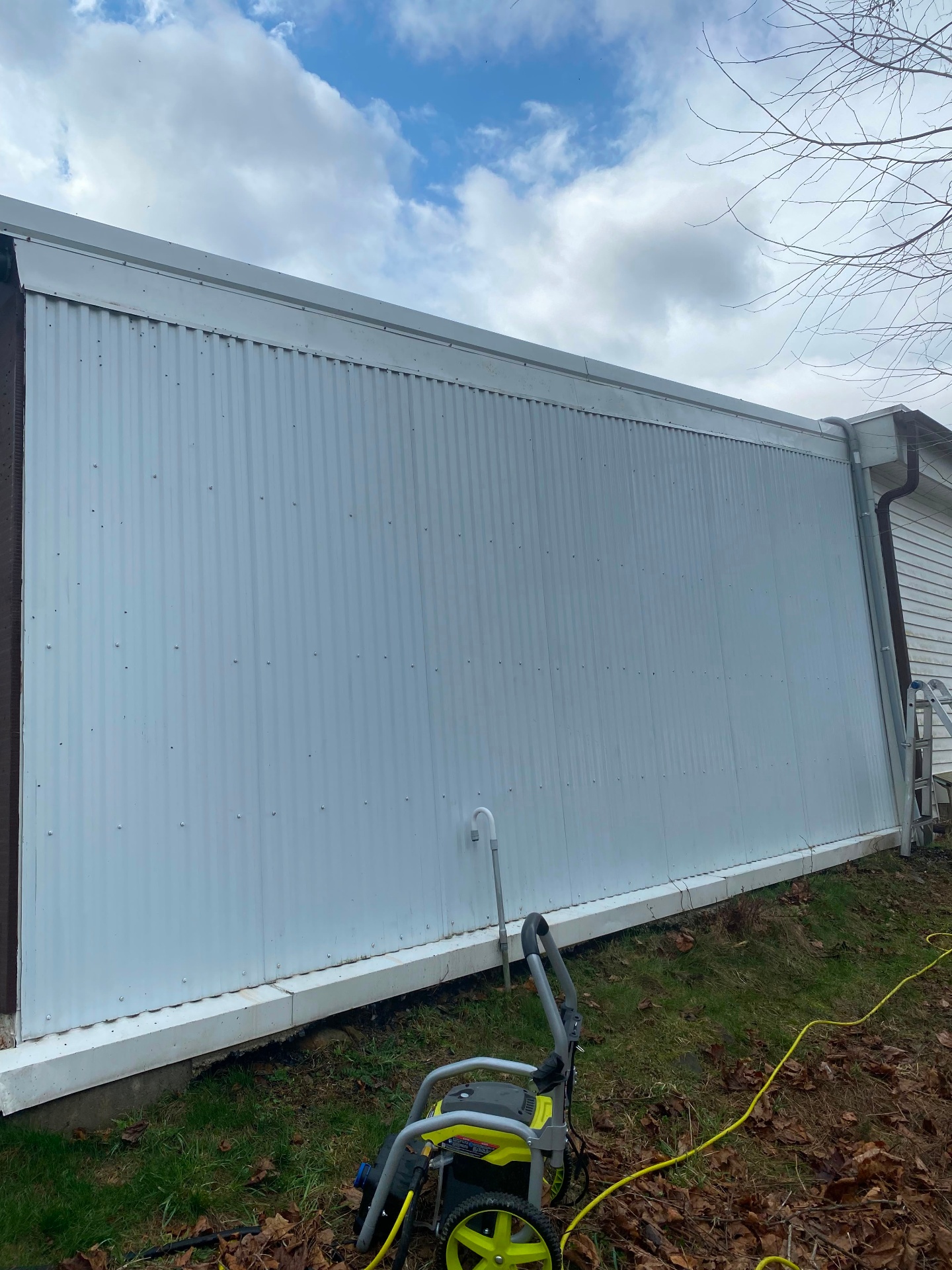 Same metal-sided wall after McGee's soft wash, algae and staining fully removed